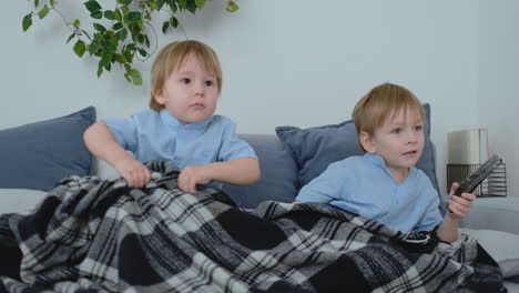 Two-children-watch-an-exciting-TV-show-on-TV.-Two-brothers-are-watching-TV